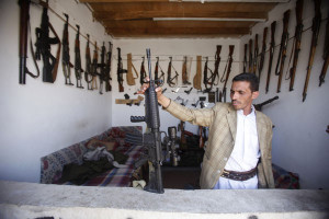 Arms dealer displays a rifle in his shop at an arms market in Jihana, around 30 km (19 miles) east of the Yemeni capital Sanaa